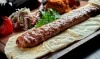 Delicious Adana Kebab recipe with grilled minced lamb, aromatic spices, and served with fresh vegetables